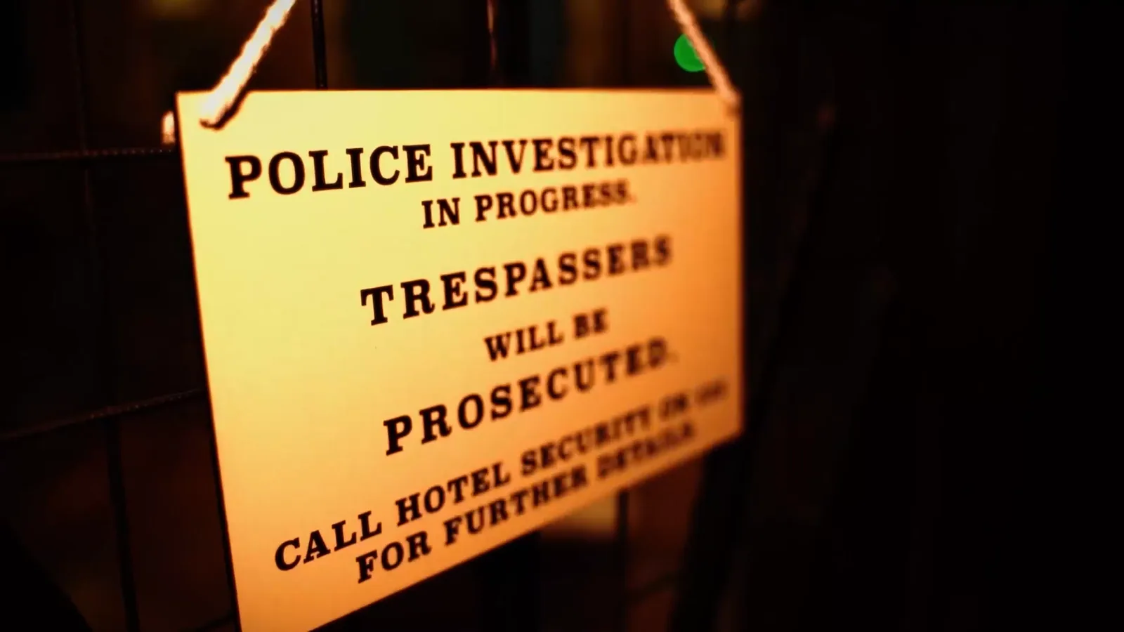 A Police Investigation in Progress notice hung on a door in Hotel: Murder Mystery
